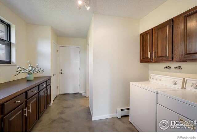 washroom featuring cabinets, independent washer and dryer, a textured ceiling, and a baseboard radiator