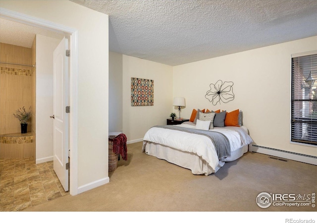 bedroom featuring carpet flooring and a textured ceiling