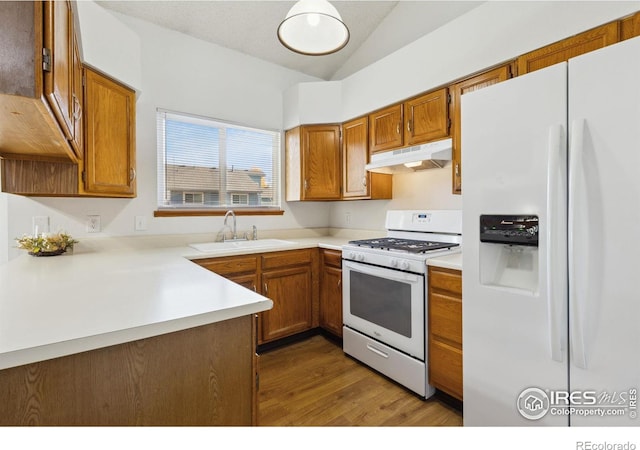 kitchen with dark hardwood / wood-style flooring, white appliances, a textured ceiling, vaulted ceiling, and sink