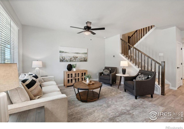 living room featuring hardwood / wood-style floors and ceiling fan