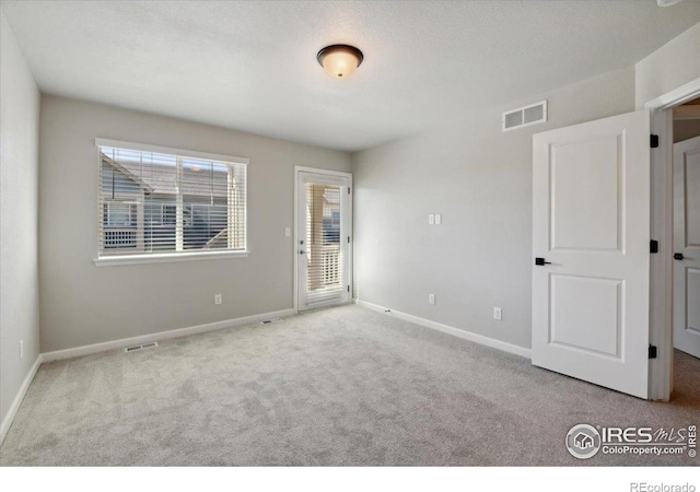 empty room featuring light carpet