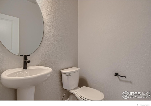 bathroom featuring sink and toilet