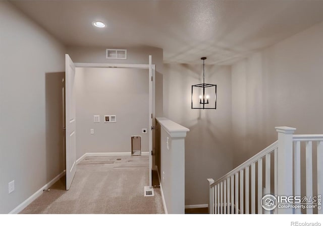 interior space featuring light carpet and an inviting chandelier