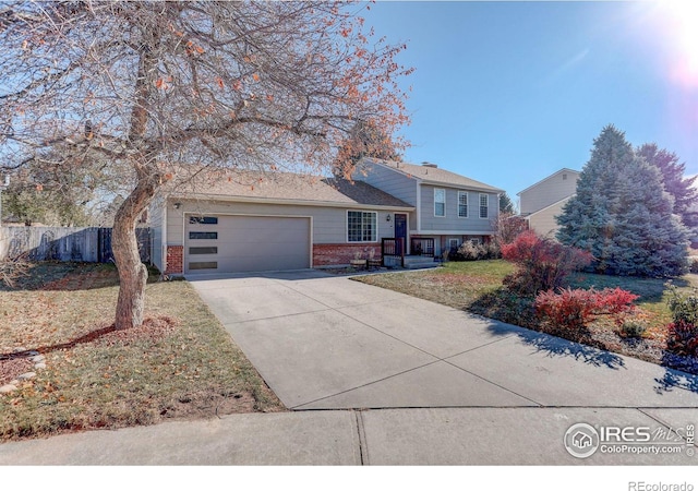 tri-level home with a front lawn and a garage