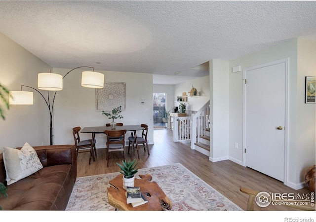 living room featuring hardwood / wood-style floors and a textured ceiling