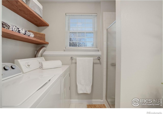 laundry area with separate washer and dryer and tile patterned floors