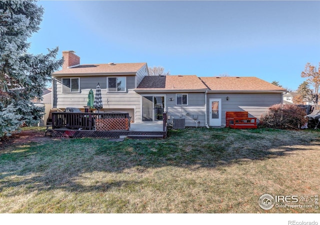 back of house with cooling unit, a yard, and a wooden deck