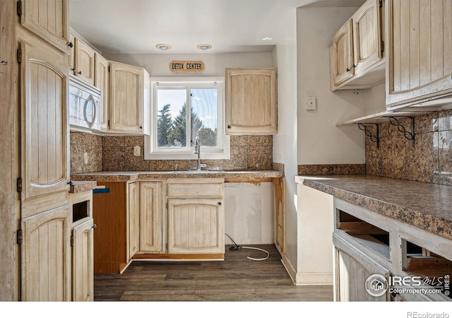 kitchen featuring light brown cabinets, backsplash, dark hardwood / wood-style floors, and sink