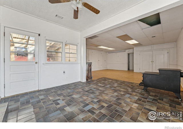 interior space featuring a paneled ceiling, ceiling fan, and dark hardwood / wood-style flooring