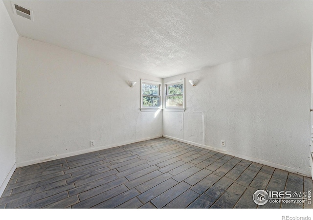 empty room with dark hardwood / wood-style flooring