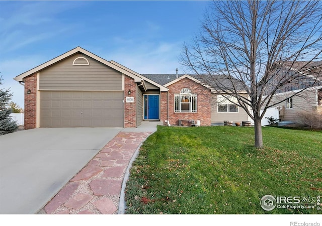 ranch-style house featuring a garage and a front lawn