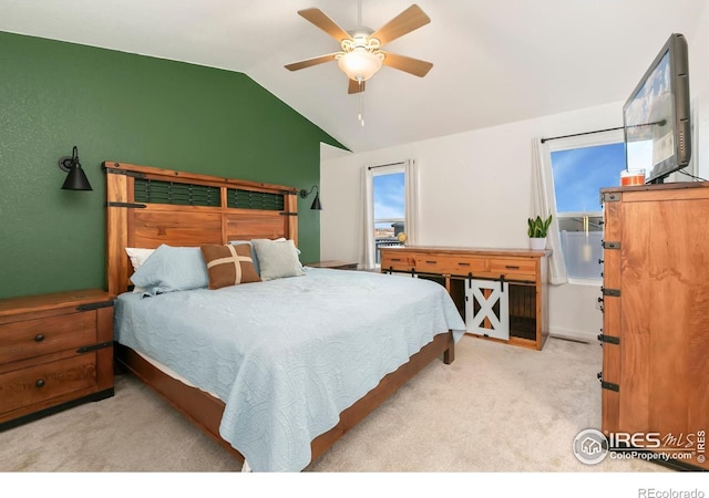 bedroom with light carpet, vaulted ceiling, and ceiling fan