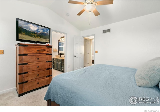 bedroom with ensuite bath, ceiling fan, light carpet, and lofted ceiling