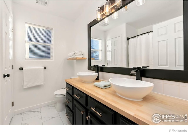 bathroom with vanity and toilet