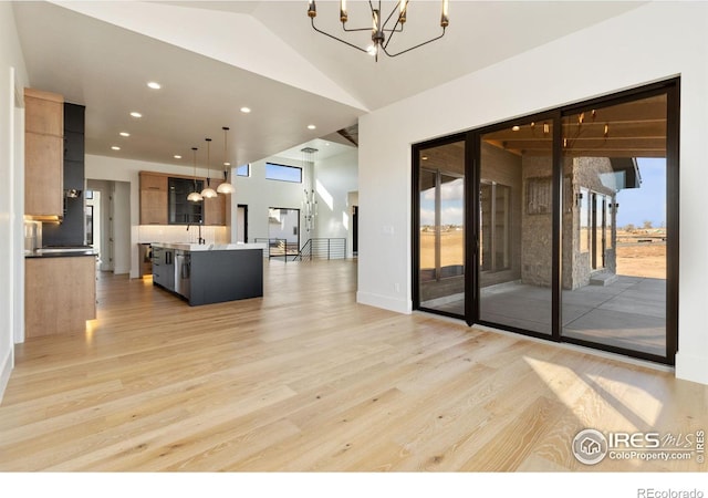 living room with a chandelier and light hardwood / wood-style flooring