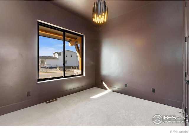 carpeted empty room with plenty of natural light