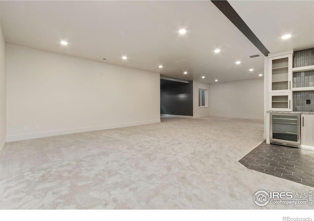 unfurnished living room with carpet flooring and wine cooler