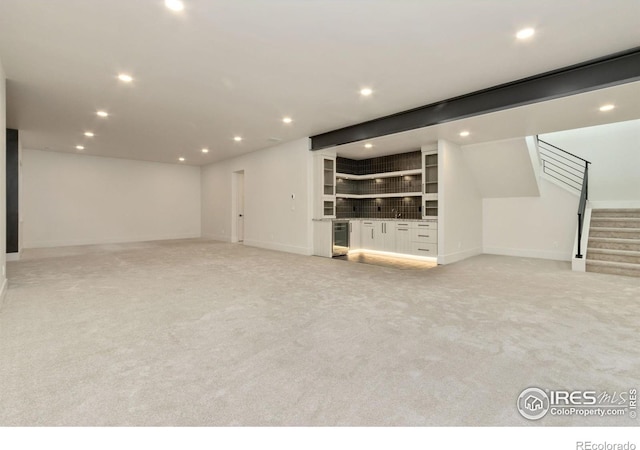 unfurnished living room featuring light colored carpet