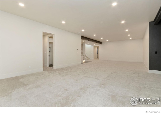 unfurnished room with light colored carpet