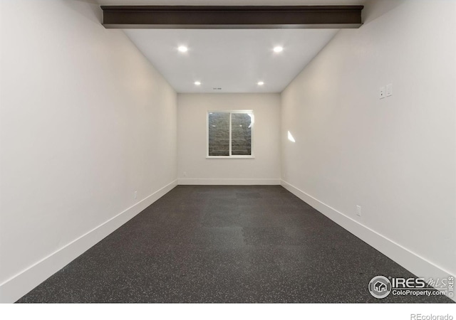 unfurnished room featuring beamed ceiling