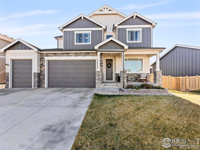 craftsman-style home featuring covered porch, a garage, and a front yard