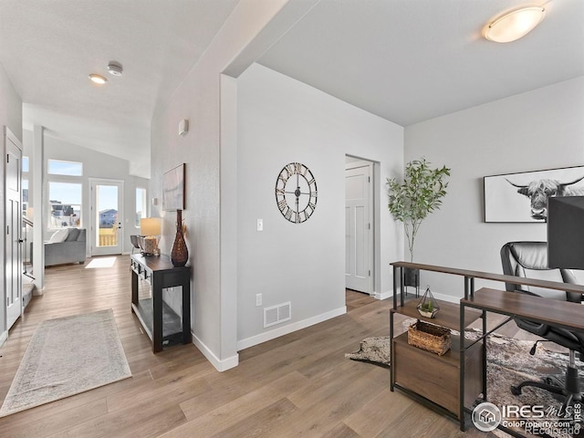 office area featuring light hardwood / wood-style floors and vaulted ceiling