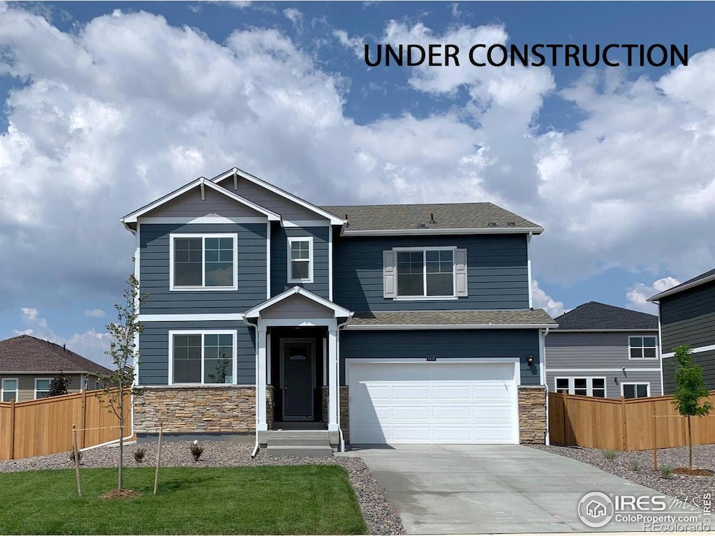 craftsman-style home with a garage and a front lawn