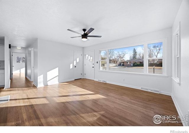 unfurnished living room with ceiling fan and hardwood / wood-style floors