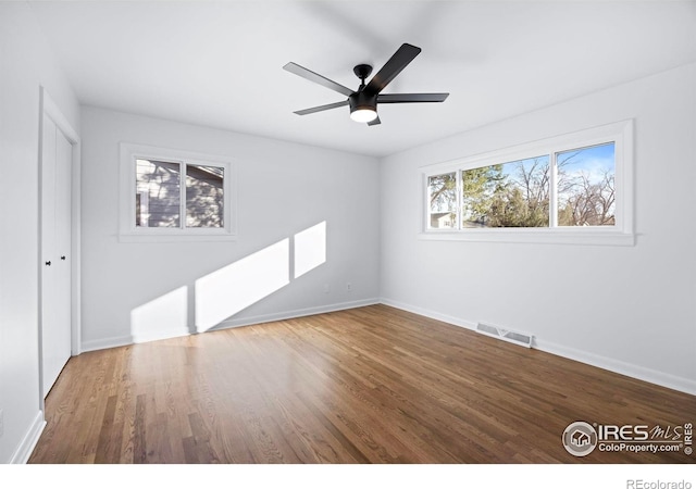 unfurnished room with ceiling fan and wood-type flooring