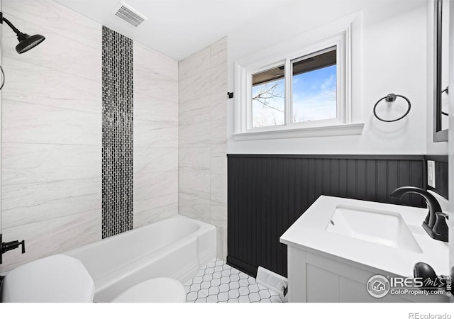 full bathroom with tile patterned flooring, vanity, toilet, and tiled shower / bath combo