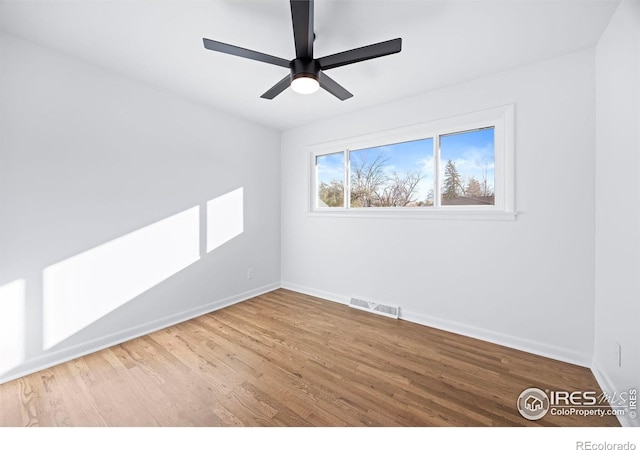 spare room featuring hardwood / wood-style flooring and ceiling fan