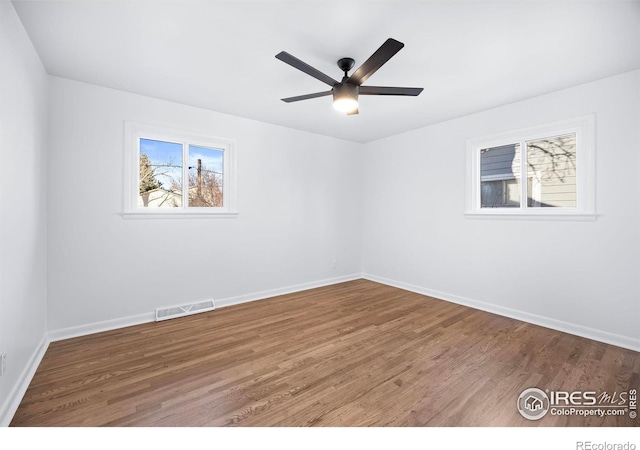 empty room featuring hardwood / wood-style floors and ceiling fan