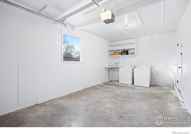 garage featuring washer and dryer and a garage door opener