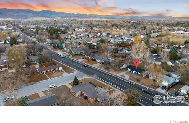 aerial view at dusk featuring a mountain view