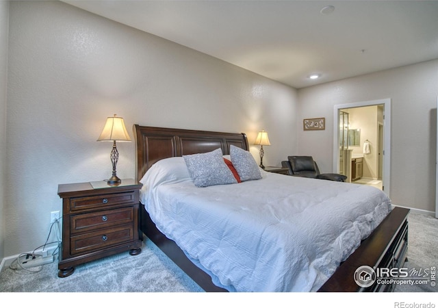 carpeted bedroom featuring connected bathroom