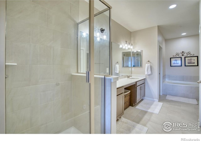 bathroom with tile patterned flooring, shower with separate bathtub, and vanity