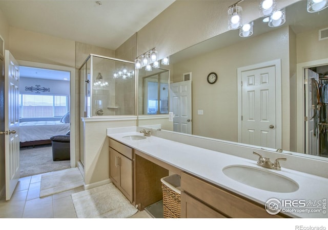 bathroom with tile patterned flooring, vanity, and an enclosed shower