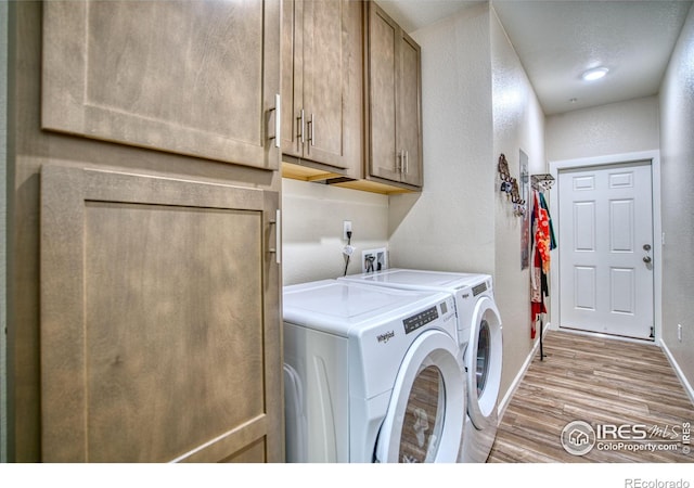 washroom with separate washer and dryer, light hardwood / wood-style flooring, cabinets, and a textured ceiling