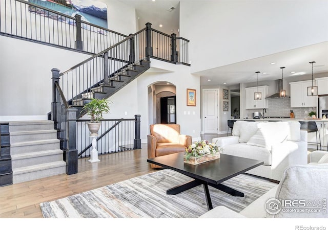 living room featuring sink and light hardwood / wood-style flooring