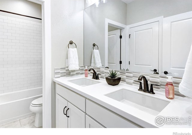 full bathroom with toilet, tasteful backsplash, vanity, tiled shower / bath combo, and tile patterned flooring