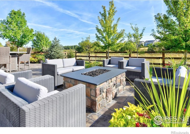 view of patio / terrace featuring an outdoor living space with a fire pit