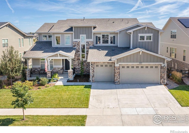 craftsman-style home with a front yard and covered porch