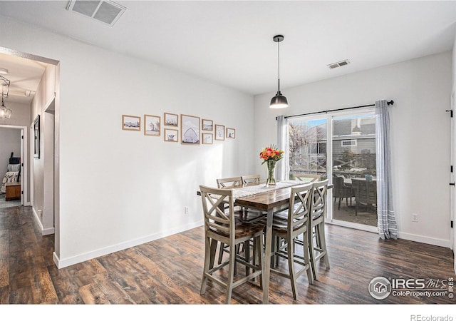 dining area with dark wood-type flooring