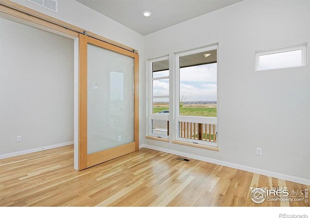 2292 Star Hill St, Longmont, CO 80503 - unfurnished room with wood finished floors, plenty of natural light, and baseboards