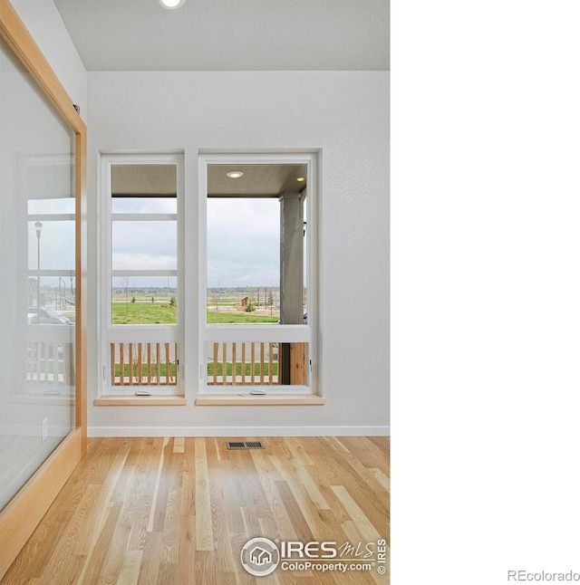 unfurnished room featuring light hardwood / wood-style floors