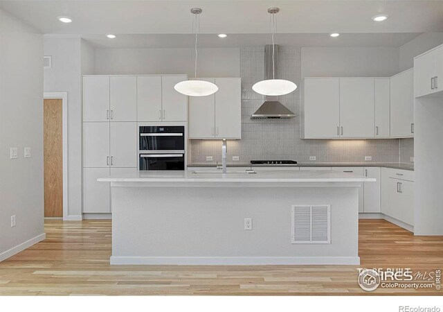 2292 Star Hill St, Longmont, CO 80503 - kitchen featuring a sink, black appliances, light wood finished floors, white cabinetry, and recessed lighting