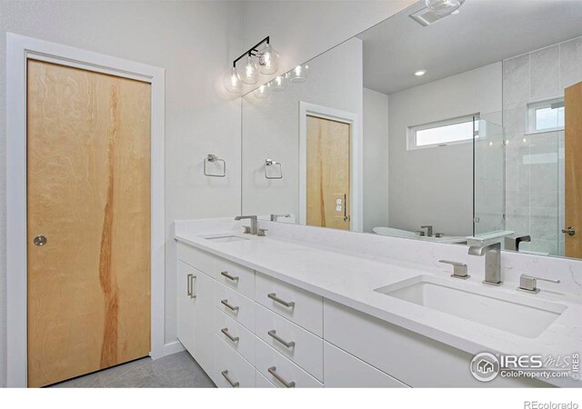 2292 Star Hill St, Longmont, CO 80503 - bathroom with double vanity, tiled shower, and toilet