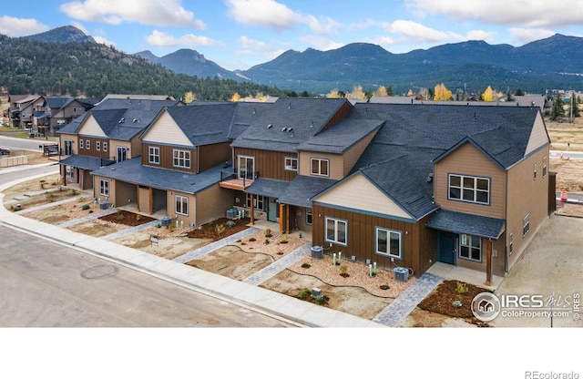 view of front facade with central AC and a mountain view