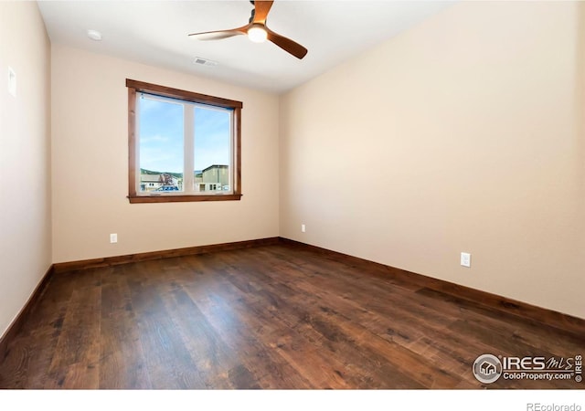 empty room featuring ceiling fan and dark hardwood / wood-style flooring