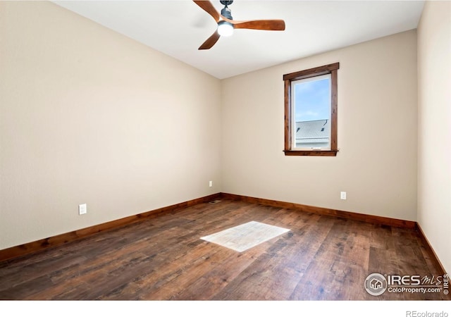 empty room featuring dark hardwood / wood-style flooring and ceiling fan